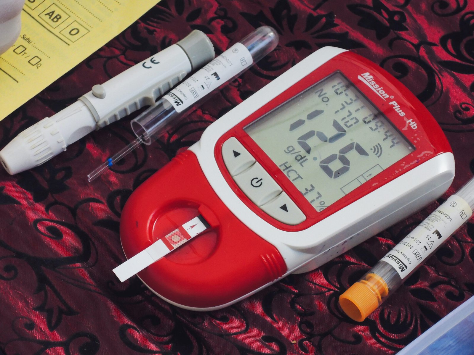 a thermometer, a pen, and two sys on a table